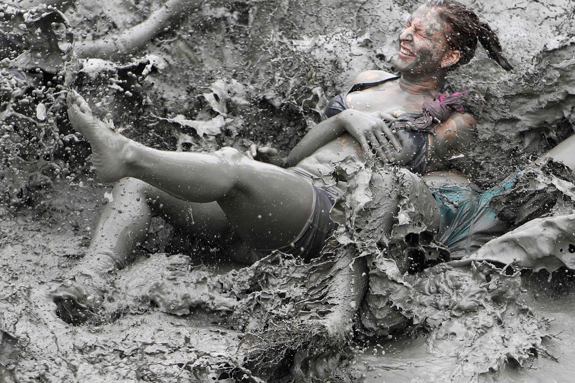 Tourists play in mud during the opening day of the Boryeong Mud Festival at Daecheon beach in Boryeong