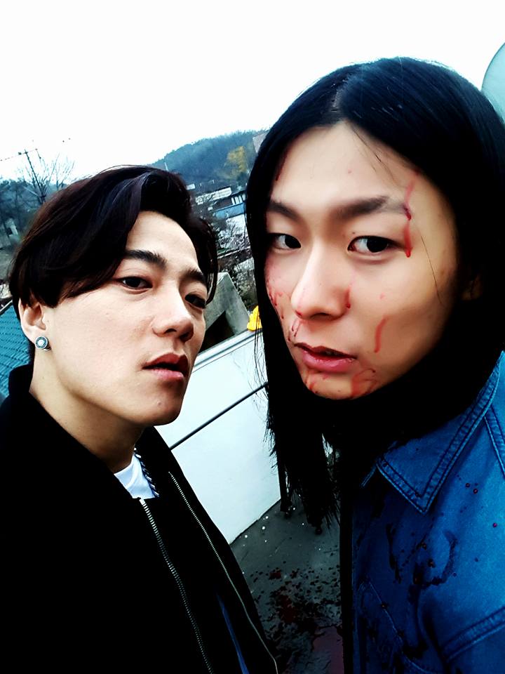 Image: Outsider with Jang Moon Bok ("Superstar K2") on "Become Stronger" MV set / Outsider's Facebook