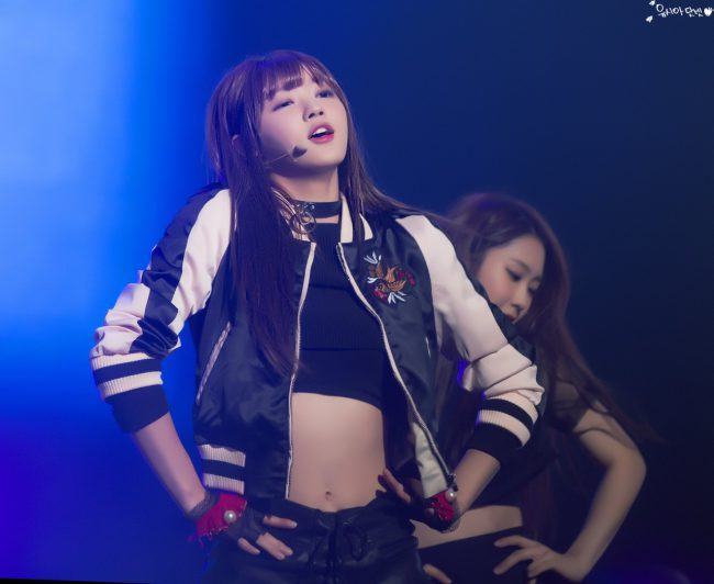 Image: Oh My Girl's YooA busting a move in a black and white bomber jacket with red and black gloves / Fan taken photo by Yoo-sia Star(Yoosia Dalbit)