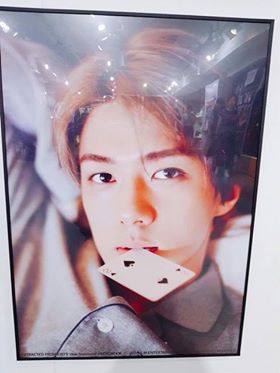 Image: EXO's Sehun Looking Playfully at the Camera with a Card / SM Entertainment
