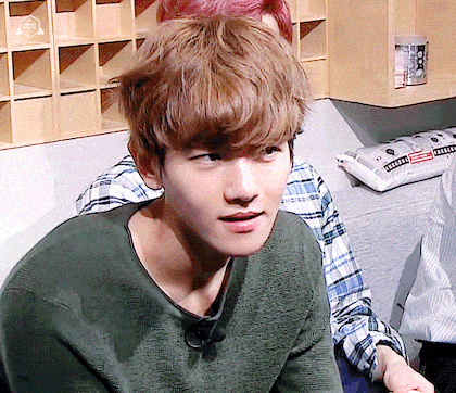 GIF of EXO's Baekhyun showing a gentle smirk while listening to their newest song on MBC's Infinite Challenge September 17, 2016 episode / Pann