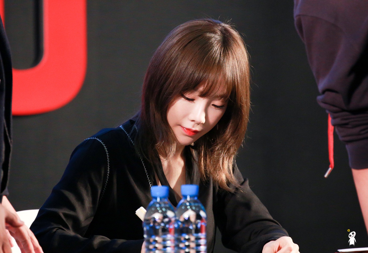 Signing diligently for the fans that came out to the event.