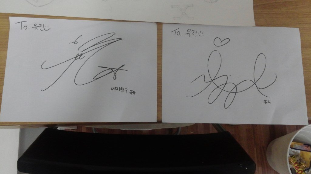 A student shares Sinbi and Umji's autographs she received. Source: Nate Pann