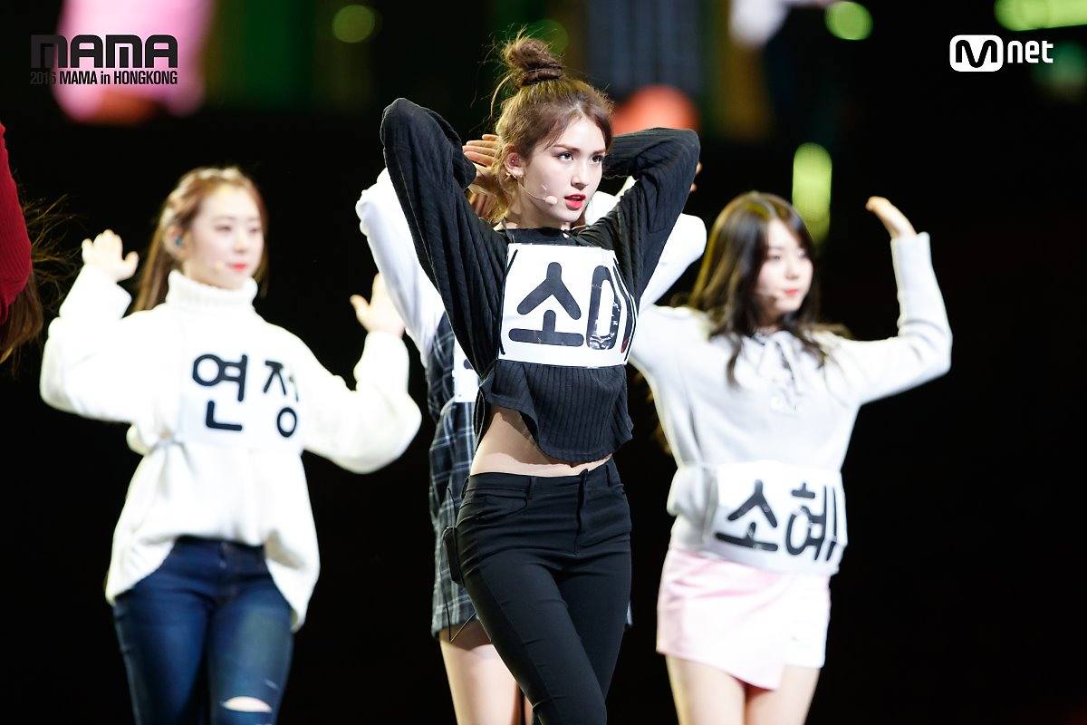 Somi exudes her strong force with her fierce eyes. Her slim waist is shown in this image. 