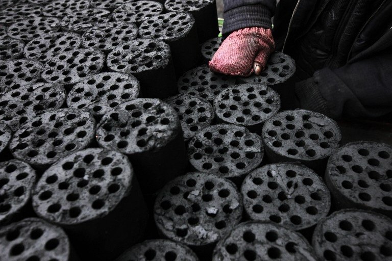 A worker moves coal briquettes onto a pedicab at a coal distribution business in Huaibei, central China's Anhui province on January 30, 2013. Environmental concerns -- particularly over the use of coal -- have been pushed to the top of the agenda after much of the country was covered with a blanket of pollution this past month. The air quality index (AQI) from the Beijing Municipal Environmental Monitoring Centre reached 993 during the worst of the pollution, almost 40 times the World Health Organisation's recommended safe limit. CHINA OUT AFP PHOTO