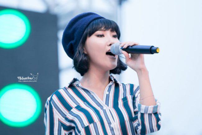 Hwasa sexily dons a beret as she sings to the crowd.